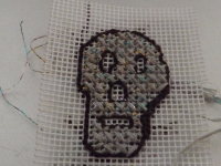 Embroidered sample of skull (backstitch + cross stich)
