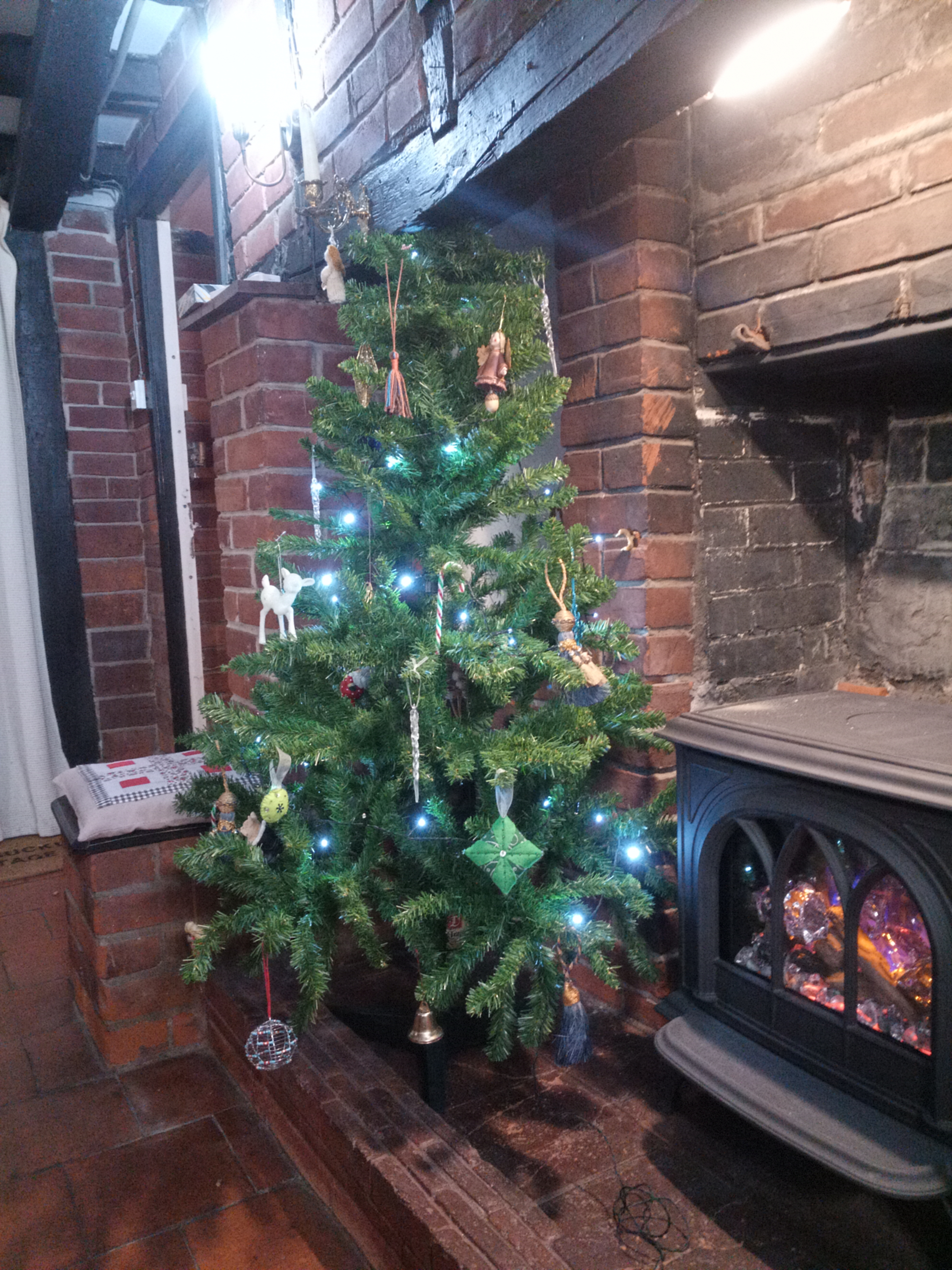 Decorated Tree Decorated Tree with lights in a fireplace