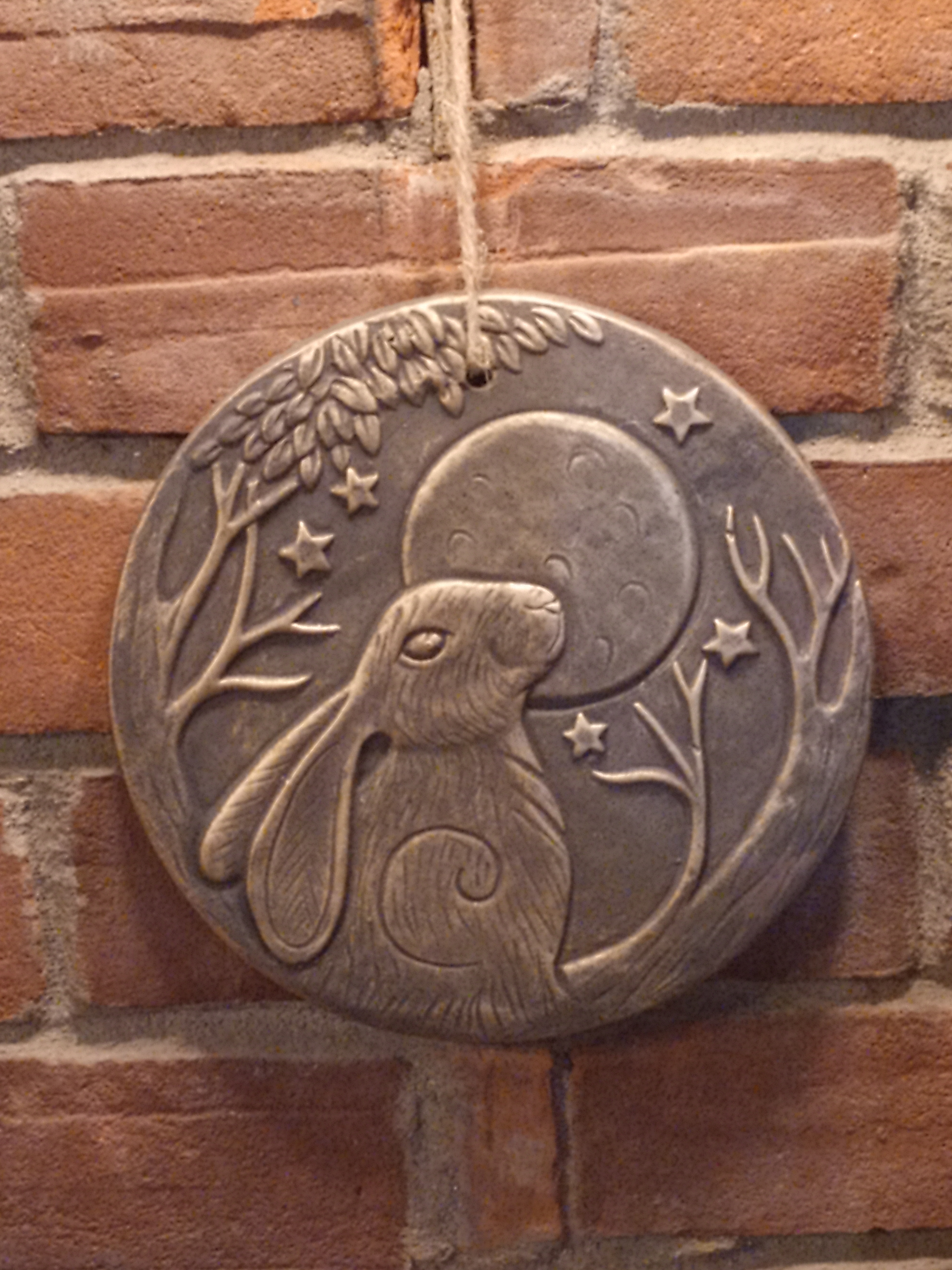 Roundel of a hare in front of a moon