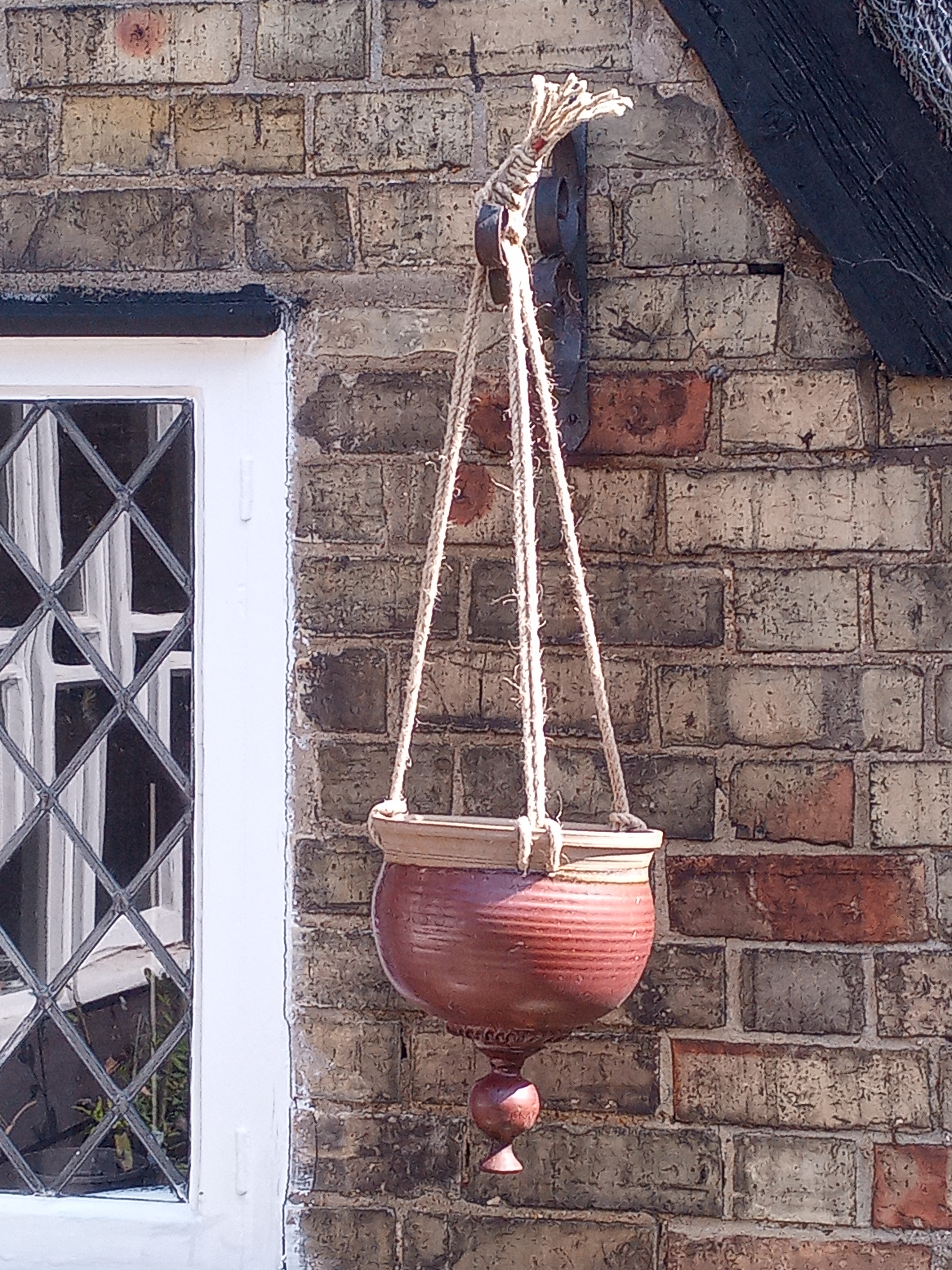 Planter hanging from wall bracket